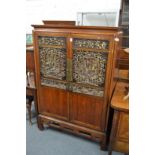 A CHINESE TWO DOOR CUPBOARD with carved and gilt decorated panelled doors. 3ft 4ins wide , 5ft