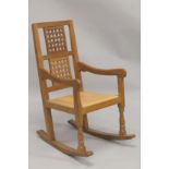 ROBERT "MOUSEMAN" THOMPSON. AN OAK ROCKING CHAIR with double lattice panel back, curving arms, close