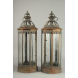 A PAIR OF COPPER AND GLASS CIRCULAR LANTERNS.