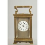 A GOOD 19TH CENTURY BRASS CARRIAGE CLOCK with column supports.