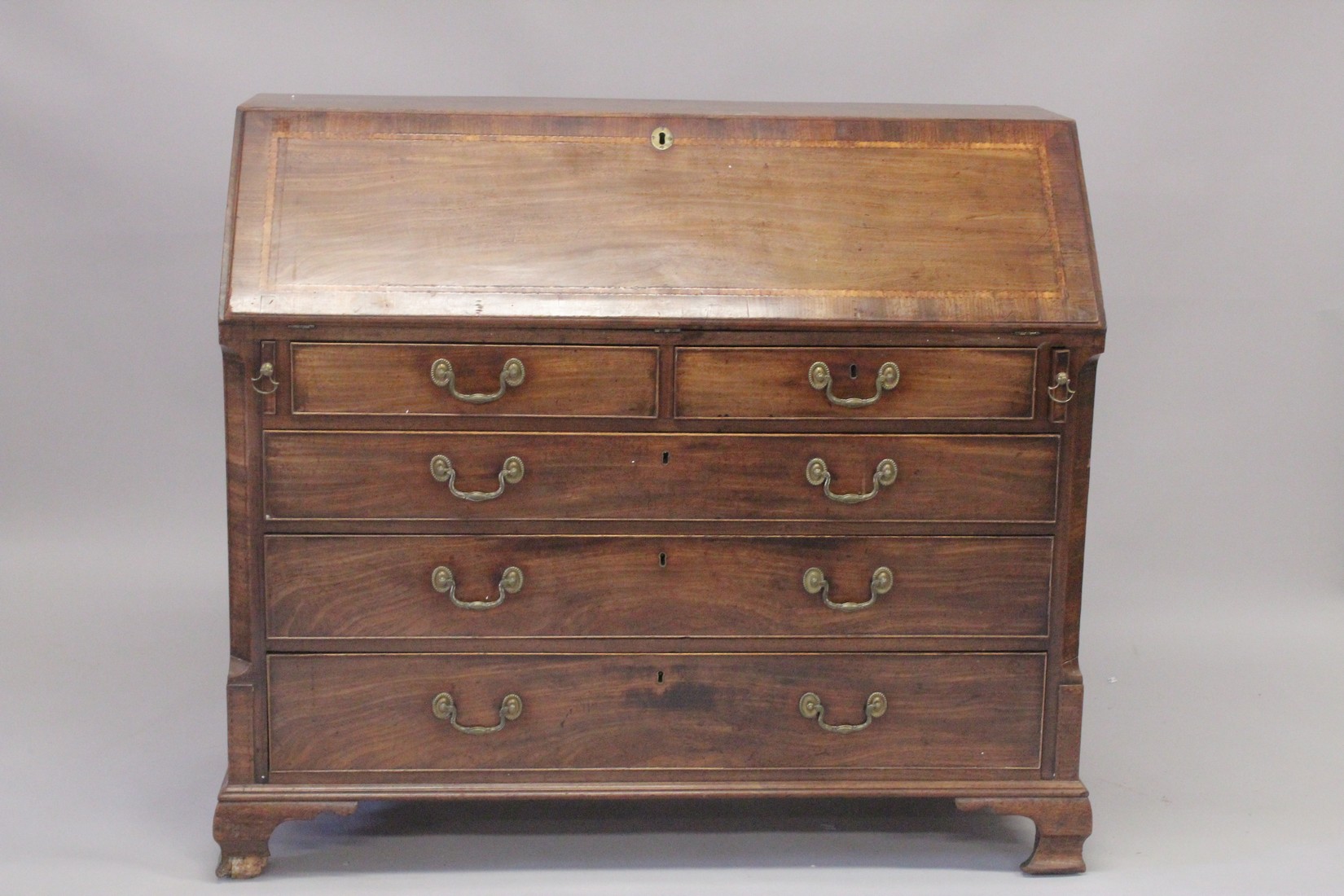 A GOOD GEORGE III MAHOGANY BUREAU with fall flap, fitted interior over two short and three long