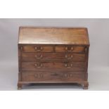 A GOOD GEORGE III MAHOGANY BUREAU with fall flap, fitted interior over two short and three long