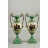 A PAIR OF SEVRES DESIGN TWO HANDLED GREEN HUNTING VASES. 13ins high.