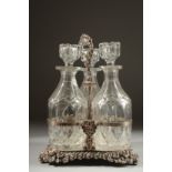 A GOOD THREE BOTTLE DECANTER STAND with three decanters and stoppers.