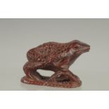 A JAPANESE CARVED WOOD FROG NETSUKE. Signed 2ins.