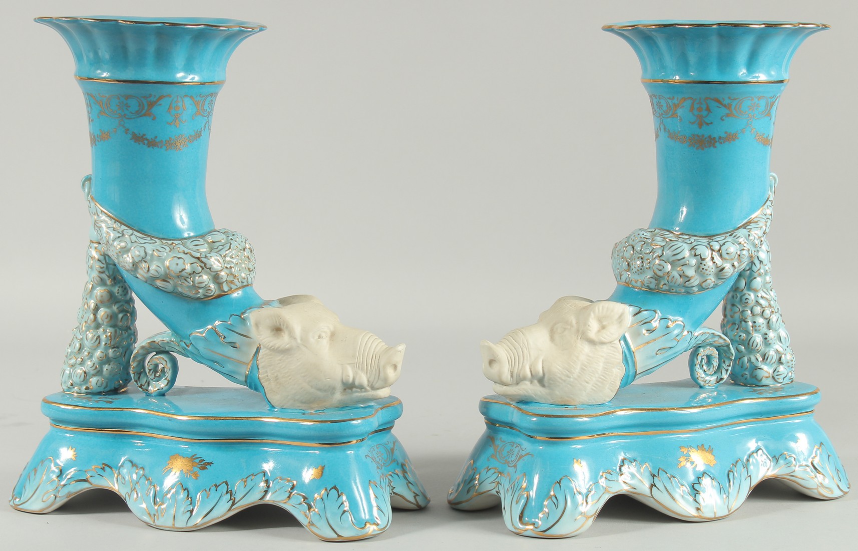 A PAIR OF SEVRES STYLE BLUE BOARS HEAD CORNUCOPIA VASES. 16ins high.