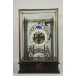 A LARGE MOONPHASE CONGREAVE CLOCK in a glass case.