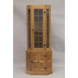 ROBERT "MOUSEMAN" THOMPSON. AN OAK STANDING CORNER CABINET, the upper section with a leaded glazed