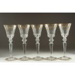 A GOOD SET OF FIVE BACCARAT CUT GLASS AND GILDED GOBLETS Inlaid J. B. 10ins high.