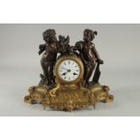 A 19TH CENTURY FRENCH BRONZE AND ORMOLU CLOCK the cover with two cherubs. 11ins high.