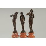 A SET OF THREE BRONZE MUSICIANS on circular marble bases 8ins.