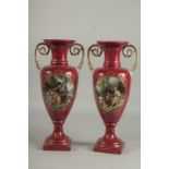 A PAIR OF SEVRES DESIGN RED PORCELAIN VASES with ovals of classical figures. 16ins high.