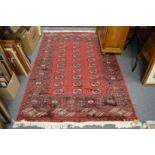 A red ground Bokara carpet 190cm x 130cm.