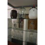 Glass terrarium, demijohns and other items.