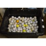 A large tub of assorted golf balls.