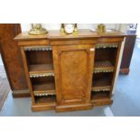 A Victorian burr walnut small breakfront bookcase with a central panelled door flanked by open