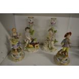 A pair of Continental porcelain figures of a boy and a girl, bears Meissen blue cross mark to the