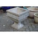 A good pair of composite garden planters of square pedestal form with moulded floral decoration.