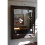 A large decoratively framed mirror.