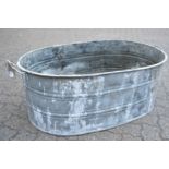 A large galvanised twin handled oval garden planter.