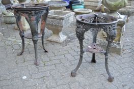 Two cast iron circular pub table bases.