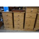 A tall narrow pine five drawer chest and a pair of similar four drawer chests.