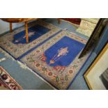 A pair of small blue ground Persian design prayer rugs each 102cm x 66cm.