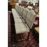 A set of eight oak framed and upholstered dining chairs.