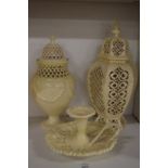 Three pieces of cream ware comprising of two vases and covers and a chamber stick.