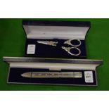 A Hallmark silver letter opener, cased and a cased pair of grape scissors.