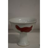 A Chinese small pedestal cup.