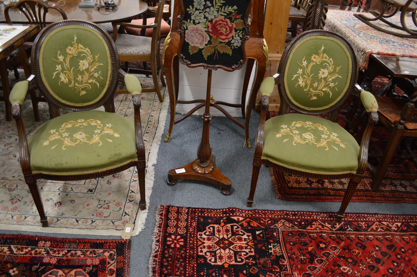 A pair of Hepplewhite style mahogany framed and upholstered open armchairs.