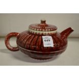 A Chinese red glaze pottery teapot.