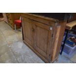 A pine two door cupboard.