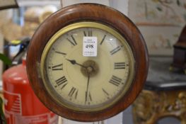 A small Continental walnut cased circular wall clock with weight driven movement.
