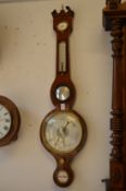 A rosewood cased aneroid barometer and thermometer.