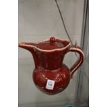 A Chinese red glazed pottery ewer.