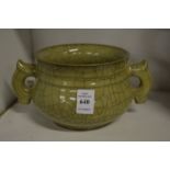 A Chinese celadon crackle glaze twin handled pottery censer.