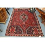 A Persian design carpet, red ground with stylised decoration 230cm x 160cm.