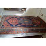 A Persian carpet, blue ground with stylised decoration 185cm x 110cm.