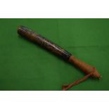 A wooden truncheon with traces of painted decoration.