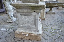 A composite square shaped pedestal stand with separate top.