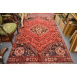A Persian design carpet, red ground with stylised decoration (slight moth damage) 285cm x 1666cm.
