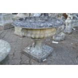 A large classical style urn shaped circular pedestal garden planter.