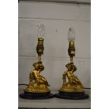 A pair of small gilt cherub table lamps.