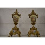 A pair of decorative ormolu and porcelain urns.