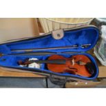 A cased violin and bow.