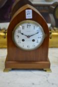 An Edwardian mahogany lancet shaped mantle clock, the enamel dial signed Maple and Co.
