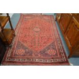 A Persian design carpet, red ground with stylised bird decoration 240cm x 155cm.
