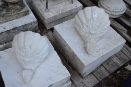 A pair of shell shaped wall pockets.